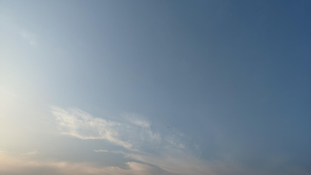 A clear blue sky with a white cloud in the sky