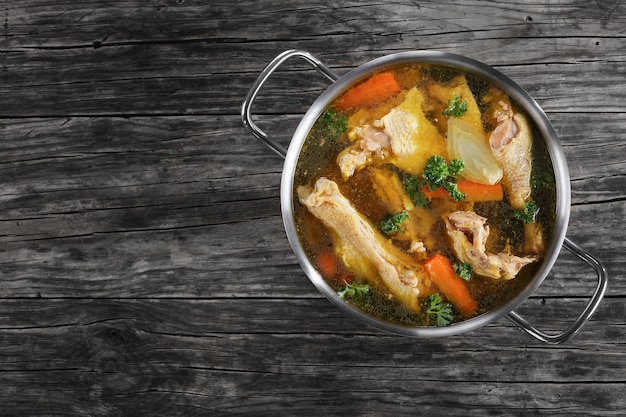 Clear broth with pieces of rooster meat