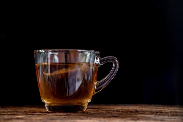 clear glass tea cup on the wood