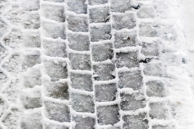 Clear imprint of a car tire on wet snow