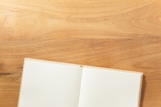 clear off-white notebook on wooden table