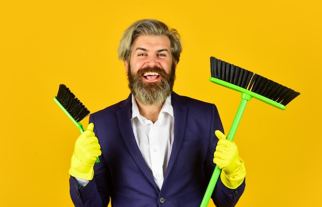 Clear reputation. bearded man formal suit hold broom brush. on guard of order. cleaning day. sweep in office. hipster enjoy cleanliness. cleaning business. household duties. cleaning service concept