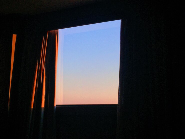 Photo clear sky seen through window during sunset
