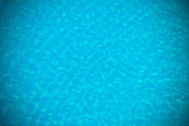 Clear transparent pool water background. Filtered blur shot