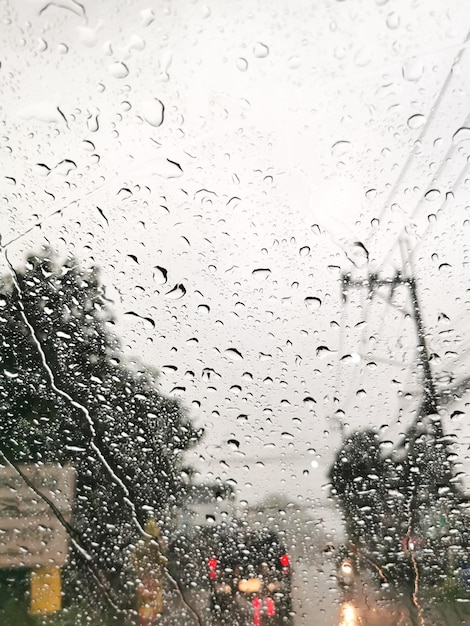 Clear water droplets on the windshield of the car after the rain while the traffic jam
