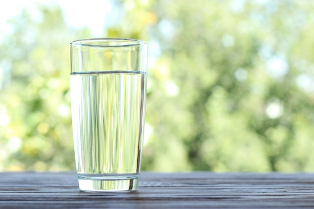 Clear water in a glass on a table on nature purified water