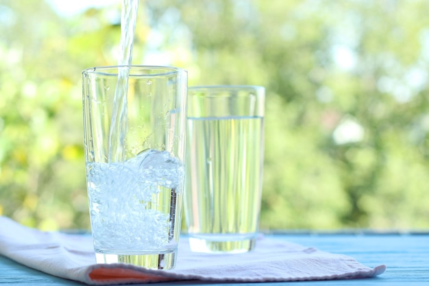 Clear water in a glass on a table on nature purified water