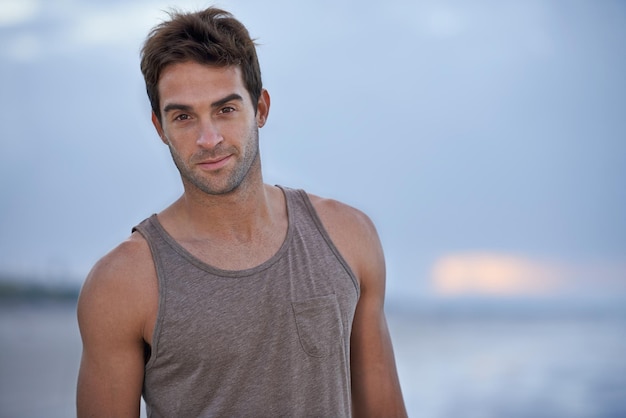 Clearing my mind beside the sea Portrait of a handsome young man one the beach in the early morning