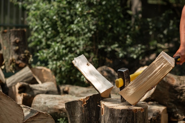 A cleaver ax sticks out in a log Firewood for kindling the stove Agriculture
