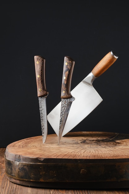 Cleaver and knives stick out of wooden blockhead