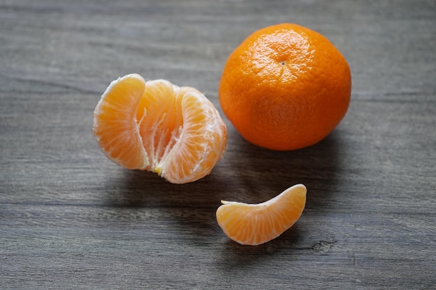 Clementines or mandarin oranges on rustic wooden table