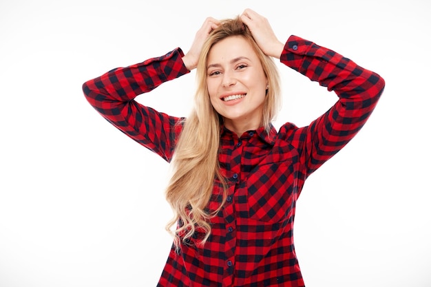 Clever blond girl touches head thinks chooses isolated on white studio background with copy space Confidence smart genius