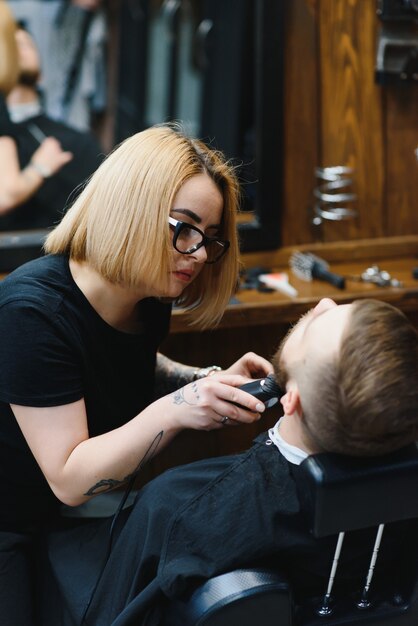 Client during beard shaving in barber shop