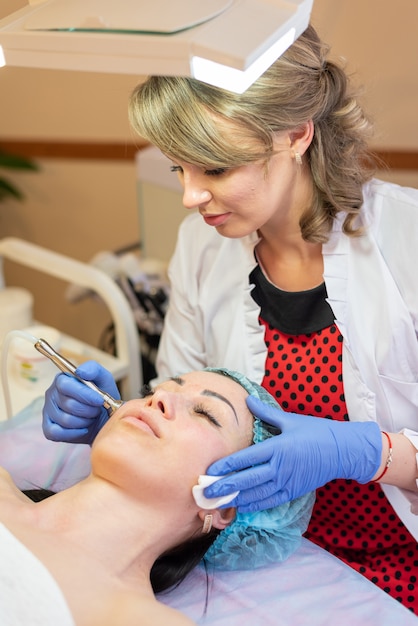 Client does facial cleansing and massage in the salon