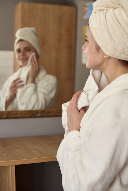 Client in front of a mirror after spa treatments in the salon