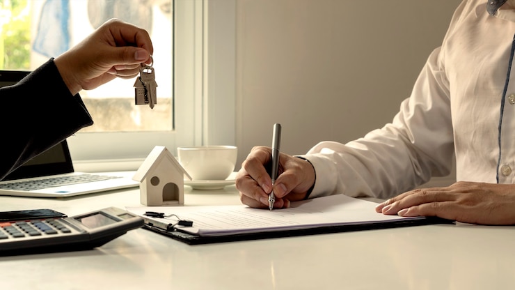 Photo the client is signing a real estate contract with an approved mortgage request form, home mortgage loan ideas, and home insurance.