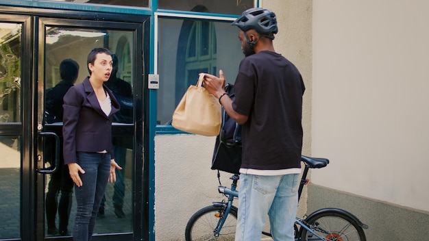 Client yelling at fastfood delivery service courier, carrier giving wrong food order to furious client at front door. Angry takeaway customer being impulsive and unsatisfied about meal.