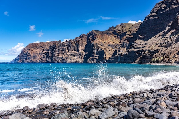 Cliffs and beach stones on the atlantic ocean coastline los gigantes tenerife canary islands spain