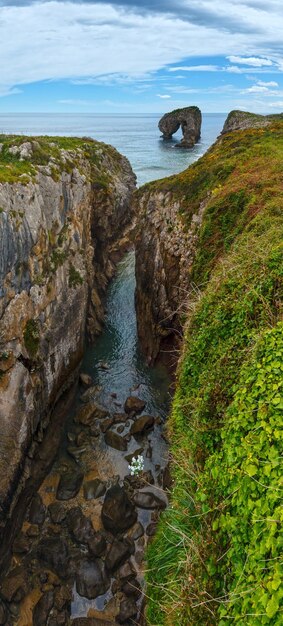 Cliffs and canyon (the islet known as Castro de las Gaviotas). Llanes Villahormes coast, Asturias, Spain.