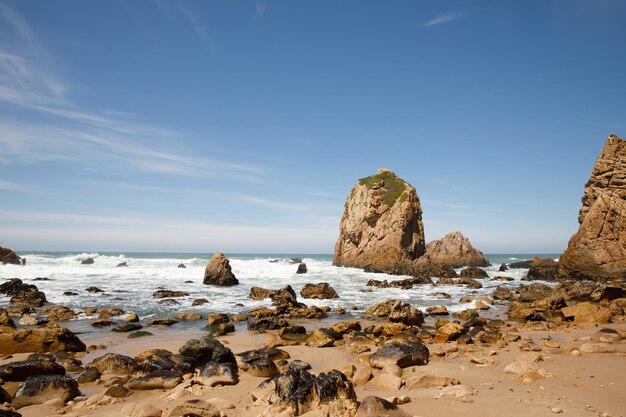 Cliffs and rocks on the Atlantic ocean coast - Praia da Ursa beach, Portugal.