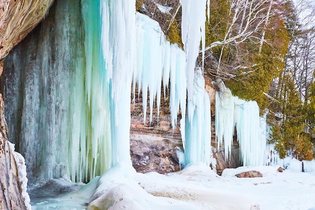 Cliffs in winter covered in giant blue icicles