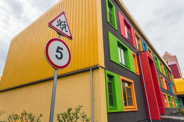 Clildren on the road sign and 5 km speed limit sign near the school