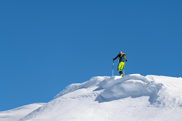 Climb with mountain skis and seal skins on a ridge