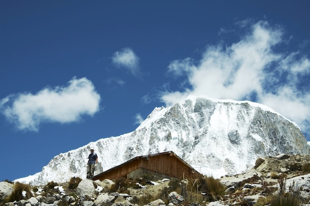 Climber,hut and Ranrapalka peak in Cordilleras