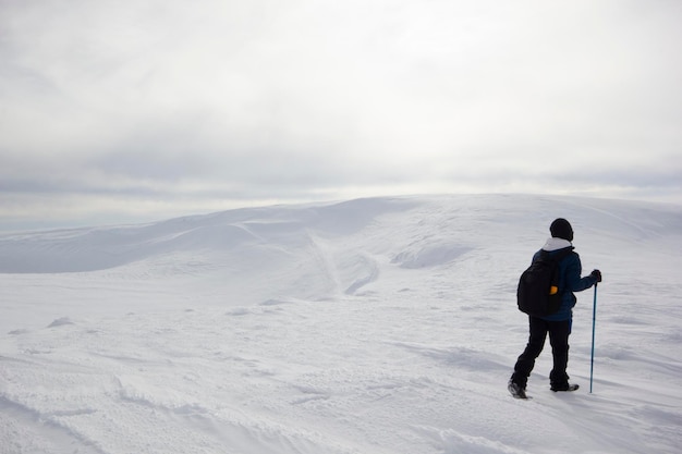 Climber man walking in the snow