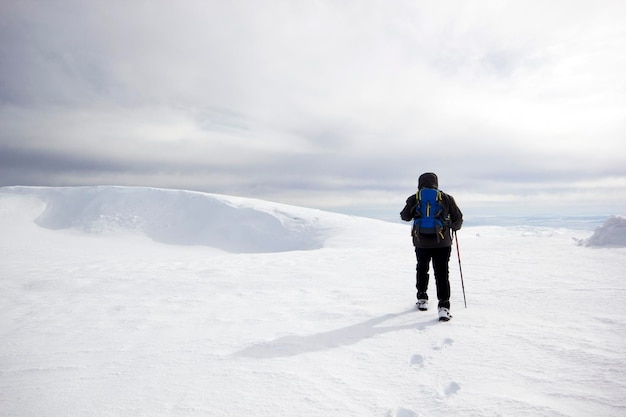 Climber man walking in the snow