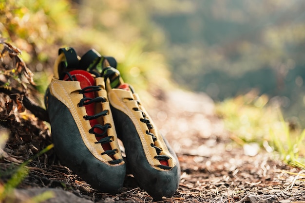 Climber wearing in climbing equipment Practicing rockclimbing on a rock mountain wall Climbing sports and bouldering concept Climber climbs on a rocky wall Climbing shoes