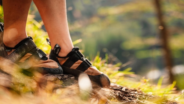 Climber wearing in climbing equipment Practicing rockclimbing on a rock mountain wall Climbing sports and bouldering concept Climber climbs on a rocky wall Climbing shoes