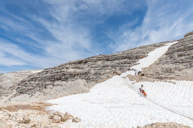 Photo climbers walking along the path to the top of the piz boe mountain.