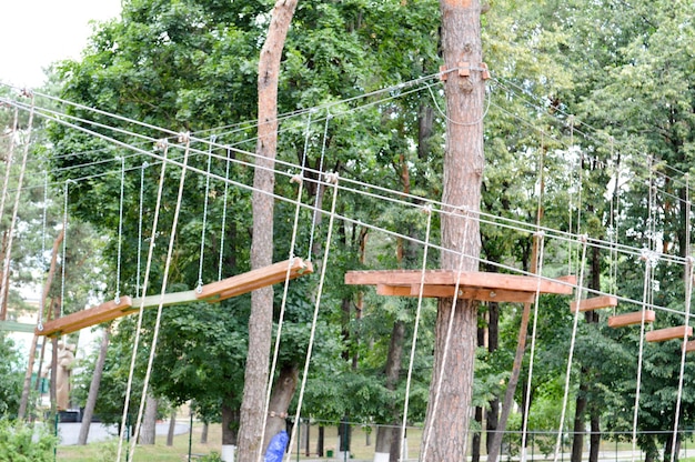 A climbing wall trolls and a rope park are sporting for games and entertainment from boards