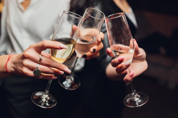 Photo clinking glasses with alcohol and toasting party