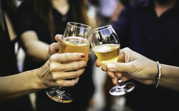 Photo clinking glasses with alcohol and toasting party