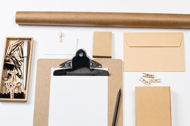 A clipboard and office supplies on a white background