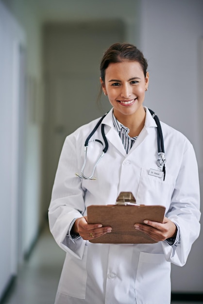 clipboard smile and portrait of doctor with results in hospital clinic and wellness facility for health in medical career female person cardiologist and healthcare professional with documents