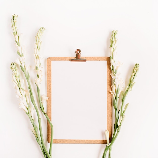 Photo clipboard and white flowers