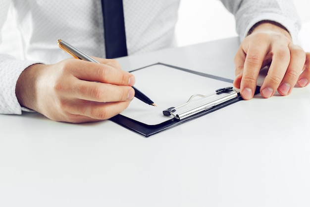 Clipboard on a white table. close up