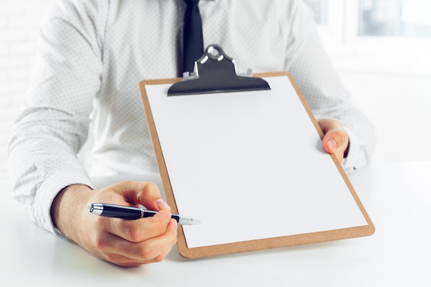 Clipboard on a white table. close up