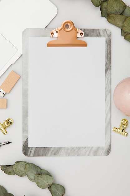 Clipboard with blank paper and accessories mockup top view