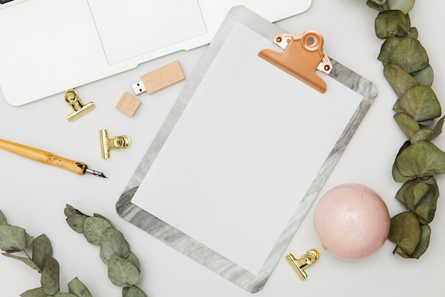 Clipboard with blank paper and accessories mockup top view