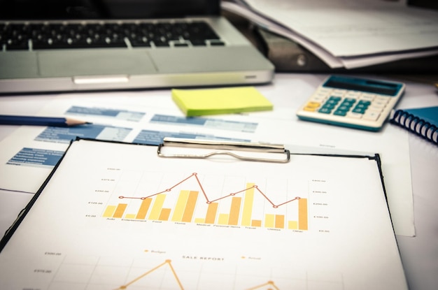 Clipboard with graph chart on table