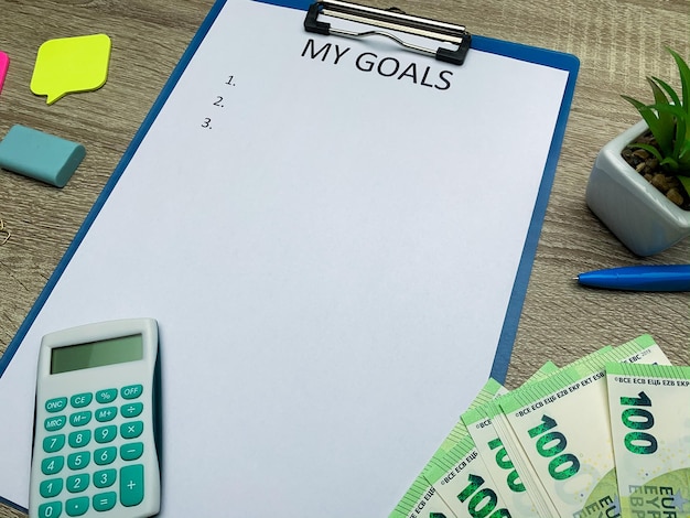 Clipboard with my goals on wood desk.