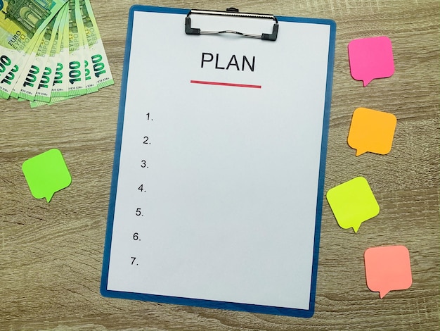 Clipboard with text plan on wood desk