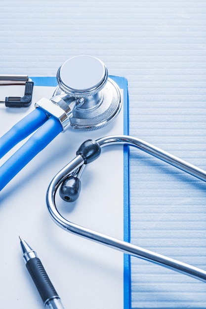 Photo clipboard with white blank paper and stethoscope on blue background medical concept