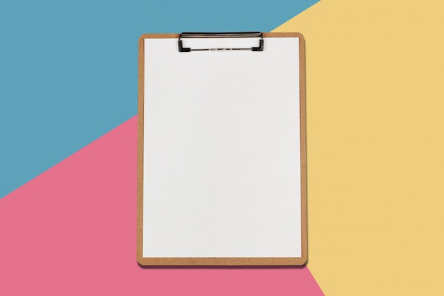 Photo clipboard with white sheet on pastel color background, minimal concept