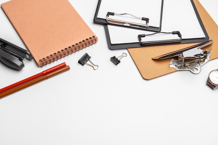 Photo clipboard with white sheet and pen isolated on a white . top view