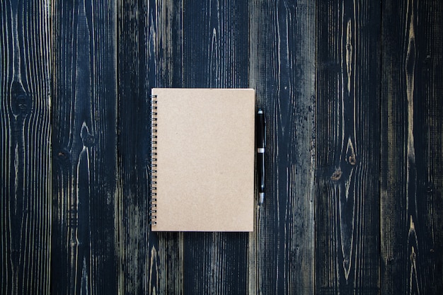 Clipboard with white sheet on wood background. Top view.Vintage style.